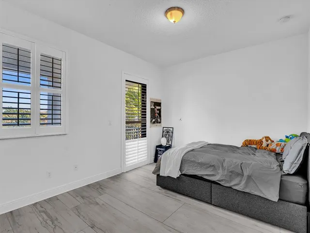 a bedroom with a bed and cabinets