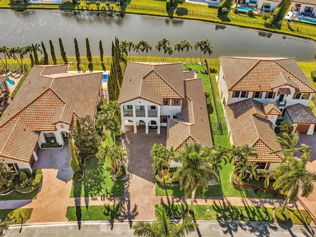 a aerial view of residential houses with outdoor space and swimming pool