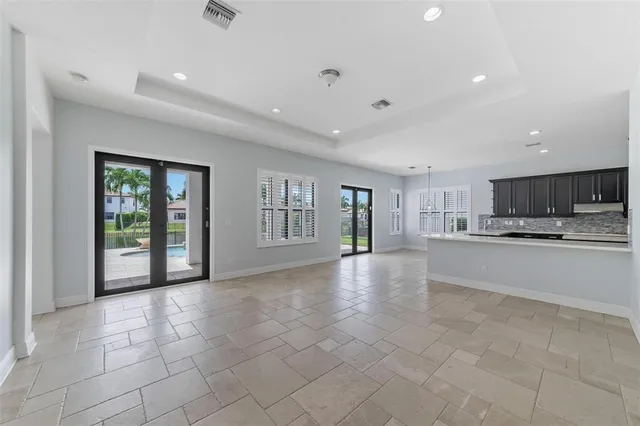 a view of large kitchen with a sink and cabinets