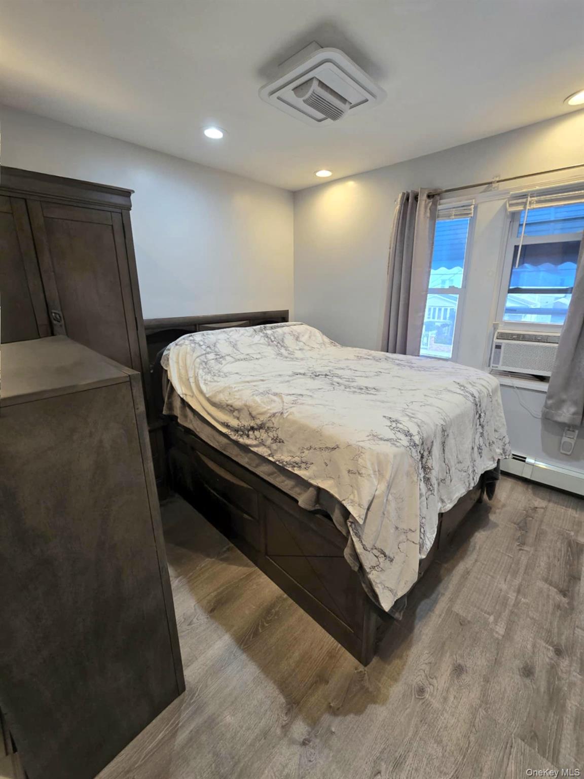 111-18 124th Street Queens, NY 11420 - Photo 16 of 16 a bed sitting in a room next to a window