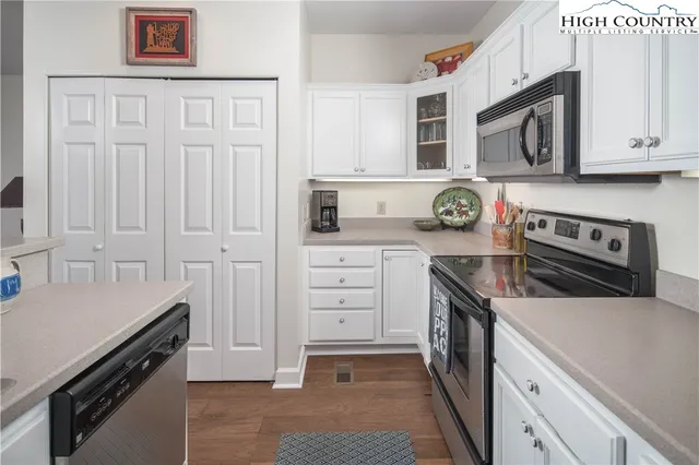a kitchen with stainless steel appliances granite countertop a stove and a microwave