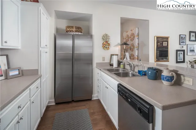 a kitchen with refrigerator and cabinets