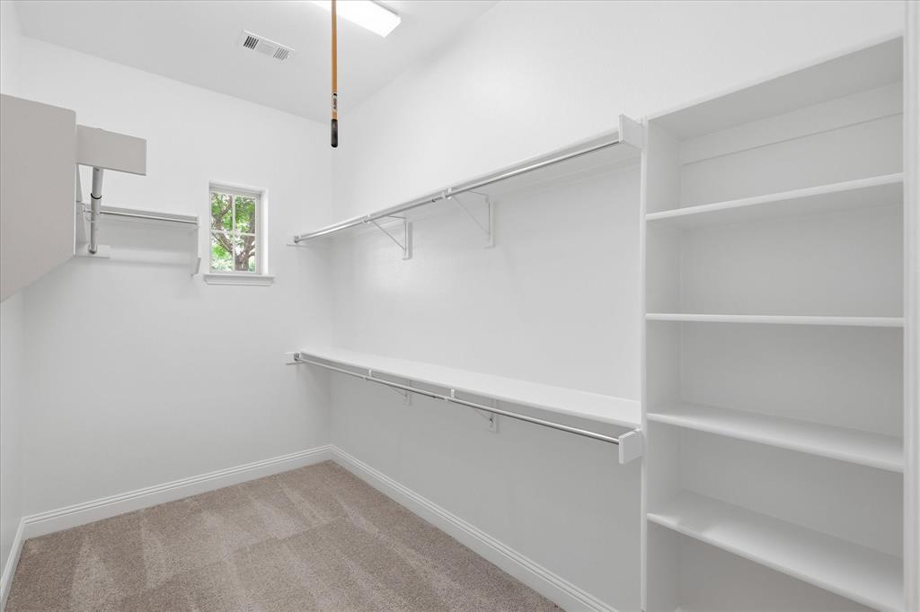 768 Huntingdon Street Coppell, TX 75019 - Photo 8 of 37 Large walk-in closet with built-in shelving, double hanging space, and plenty of room for organized storage.