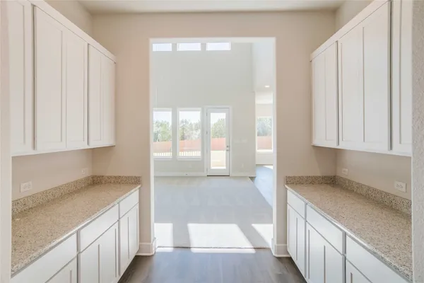 a kitchen with stainless steel appliances granite countertop a sink and a wooden floors