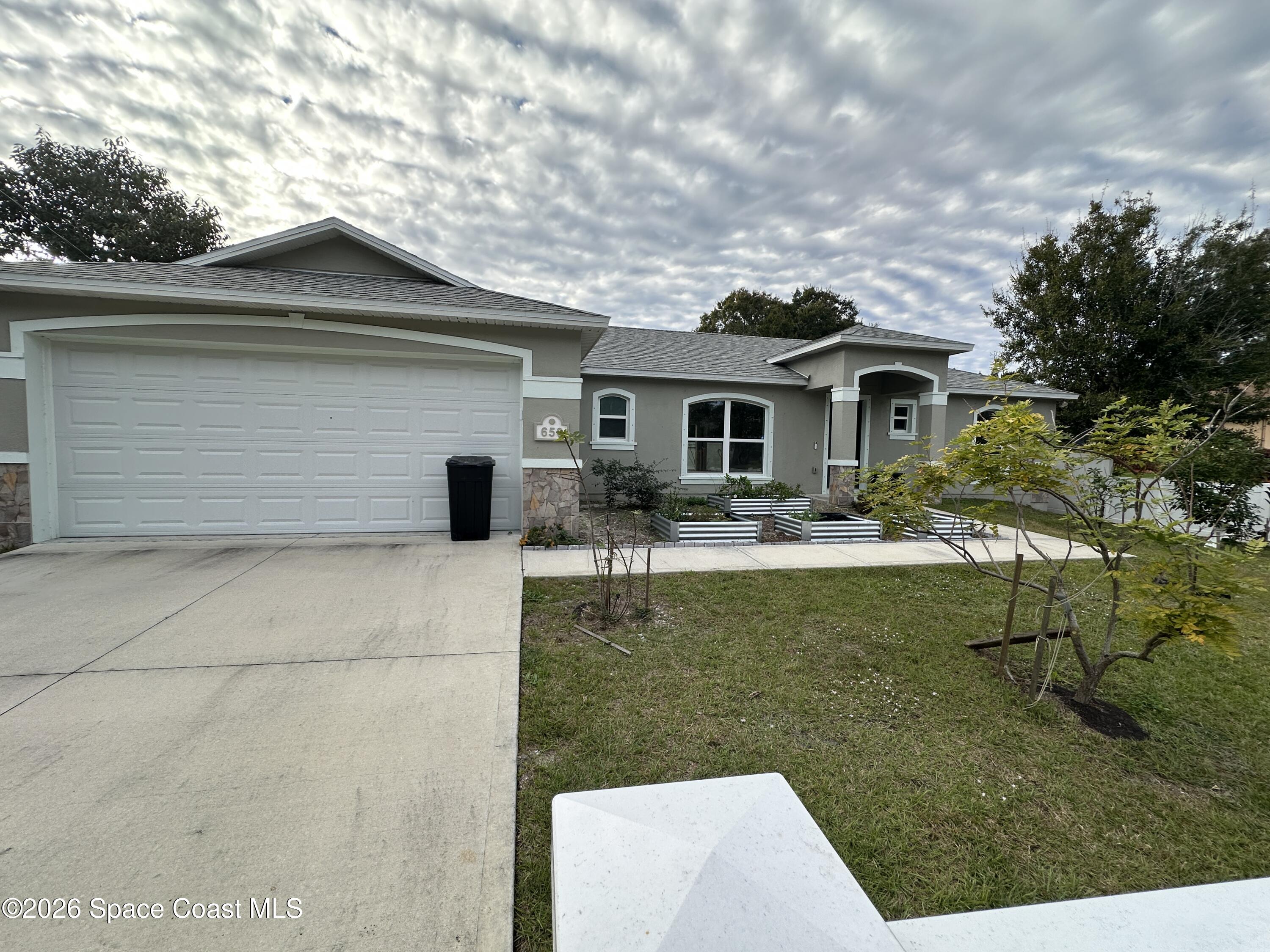 a front view of a house with garden