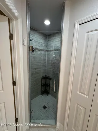 a bathroom with a shower and a sink