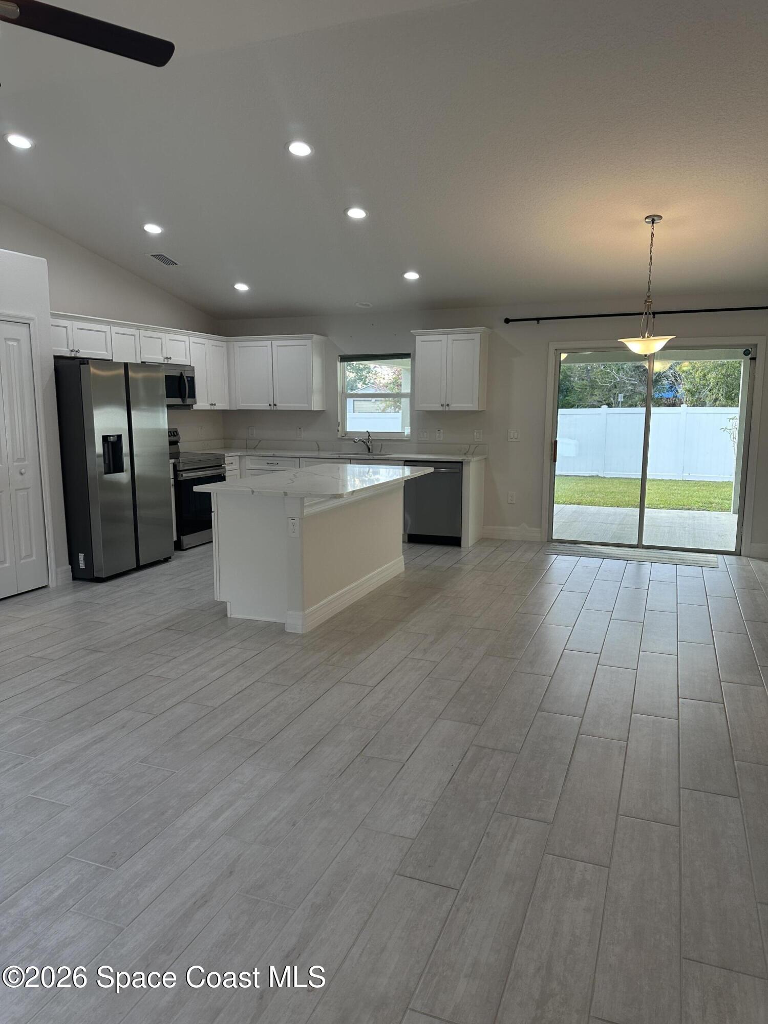 650 Rockinghorse Road Melbourne, FL 32935 - Photo 2 of 16 a view of kitchen with stainless steel appliances wooden floor and window