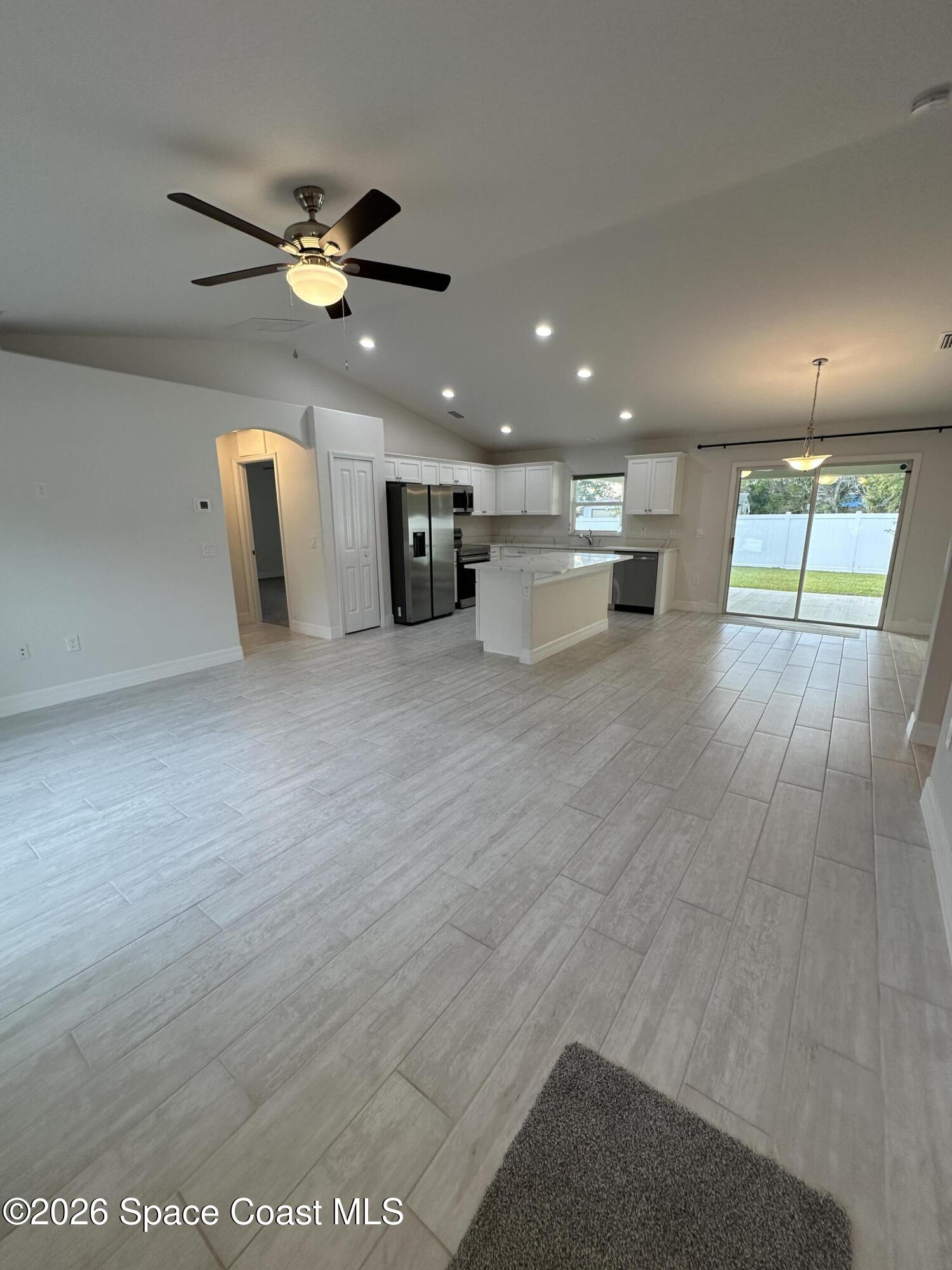 650 Rockinghorse Road Melbourne, FL 32935 - Photo 3 of 16 a view of an empty room with a window and wooden floor