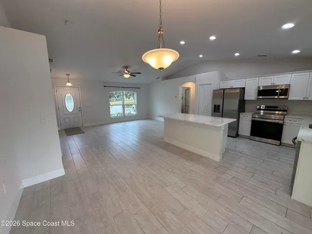 a view of a kitchen with a stove cabinets and wooden floor
