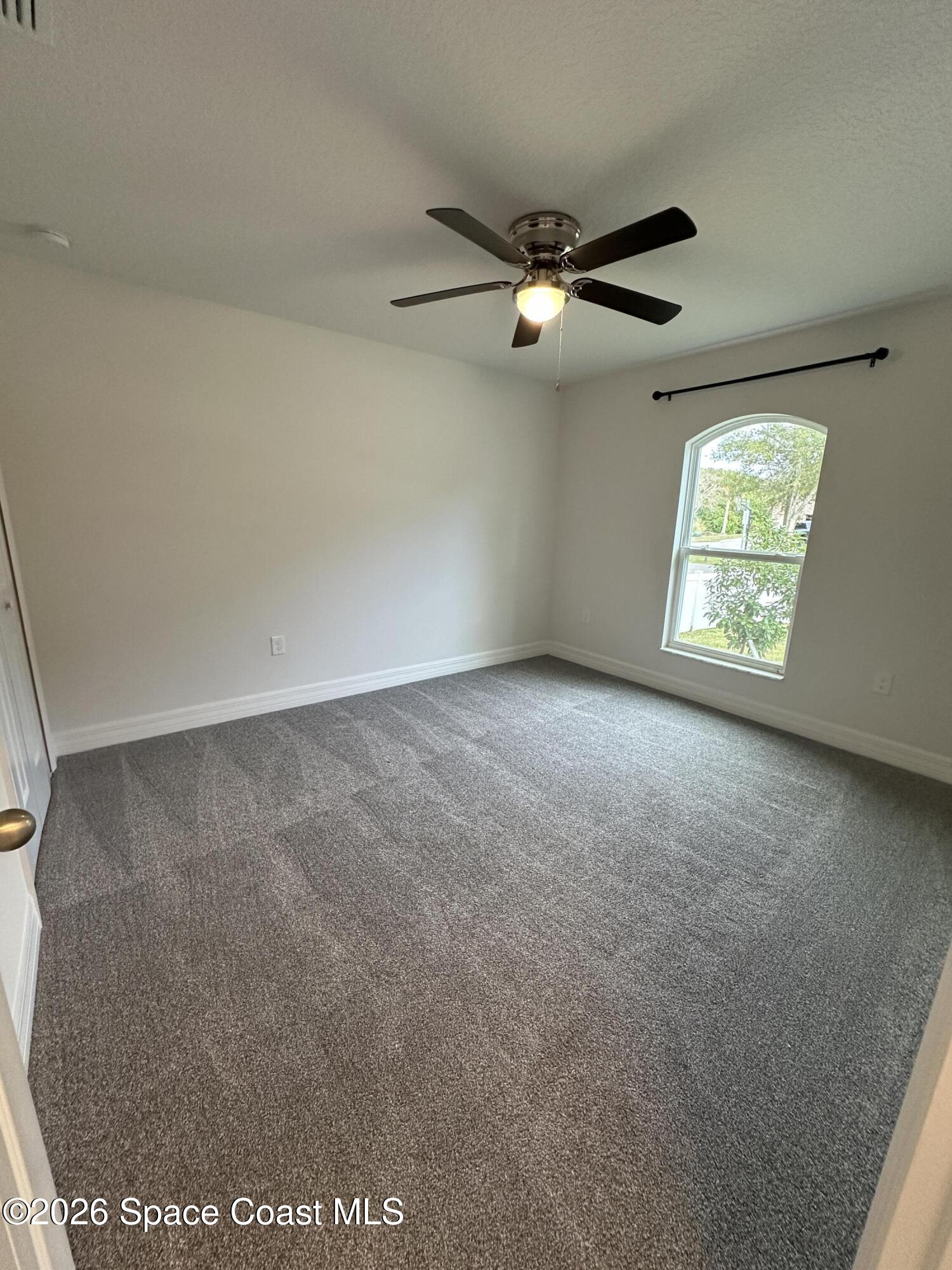 650 Rockinghorse Road Melbourne, FL 32935 - Photo 9 of 16 an empty room with windows and fan