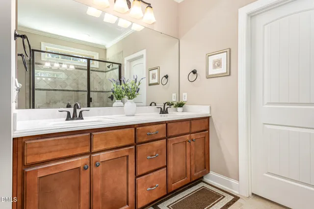 a bathroom with a double vanity sink and mirror
