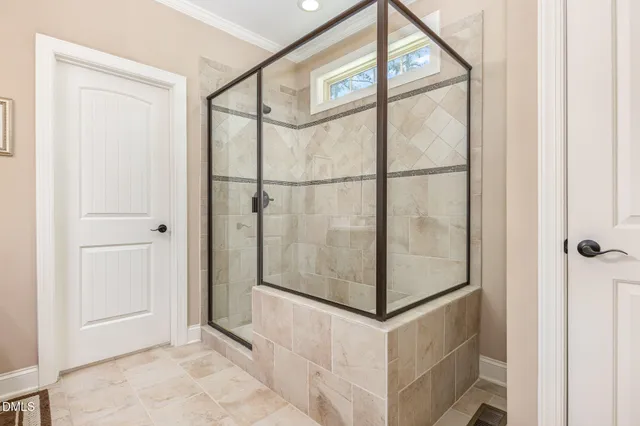 a bathroom with a glass shower door