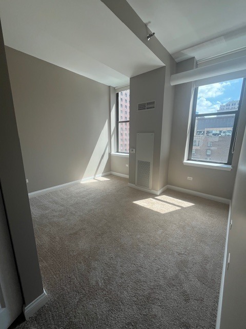 8 West Monroe Street, Unit 1102 Chicago, IL 60603 - Photo 6 of 18 a view of empty room with window