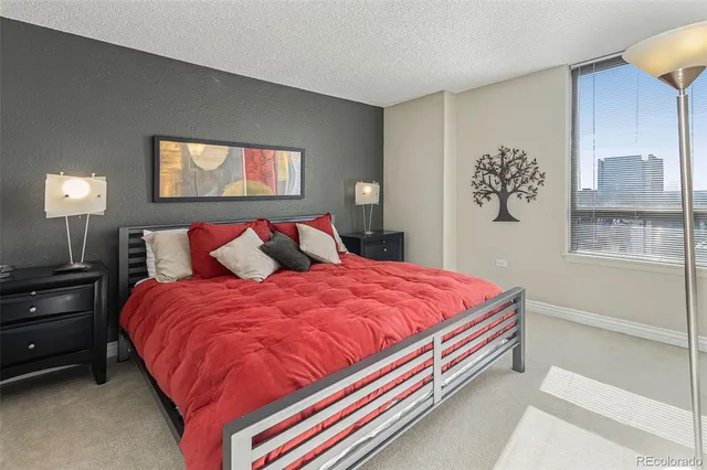 a bed sitting in a bedroom next to a window