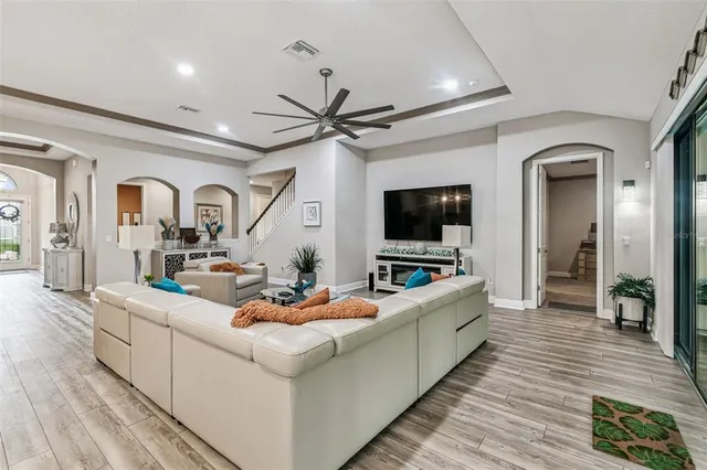 a kitchen with stainless steel appliances kitchen island granite countertop a table chairs sink and cabinets