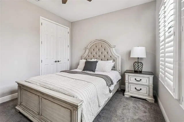 a bed room with a bed and a chair