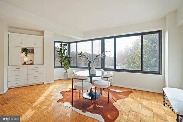 a reading room with furniture and next to a window