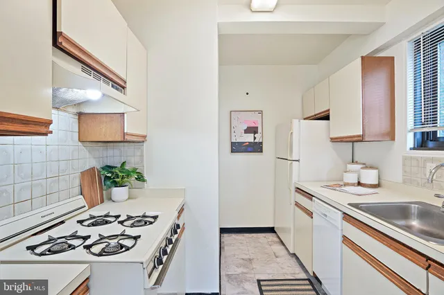 a kitchen with a sink stove and refrigerator
