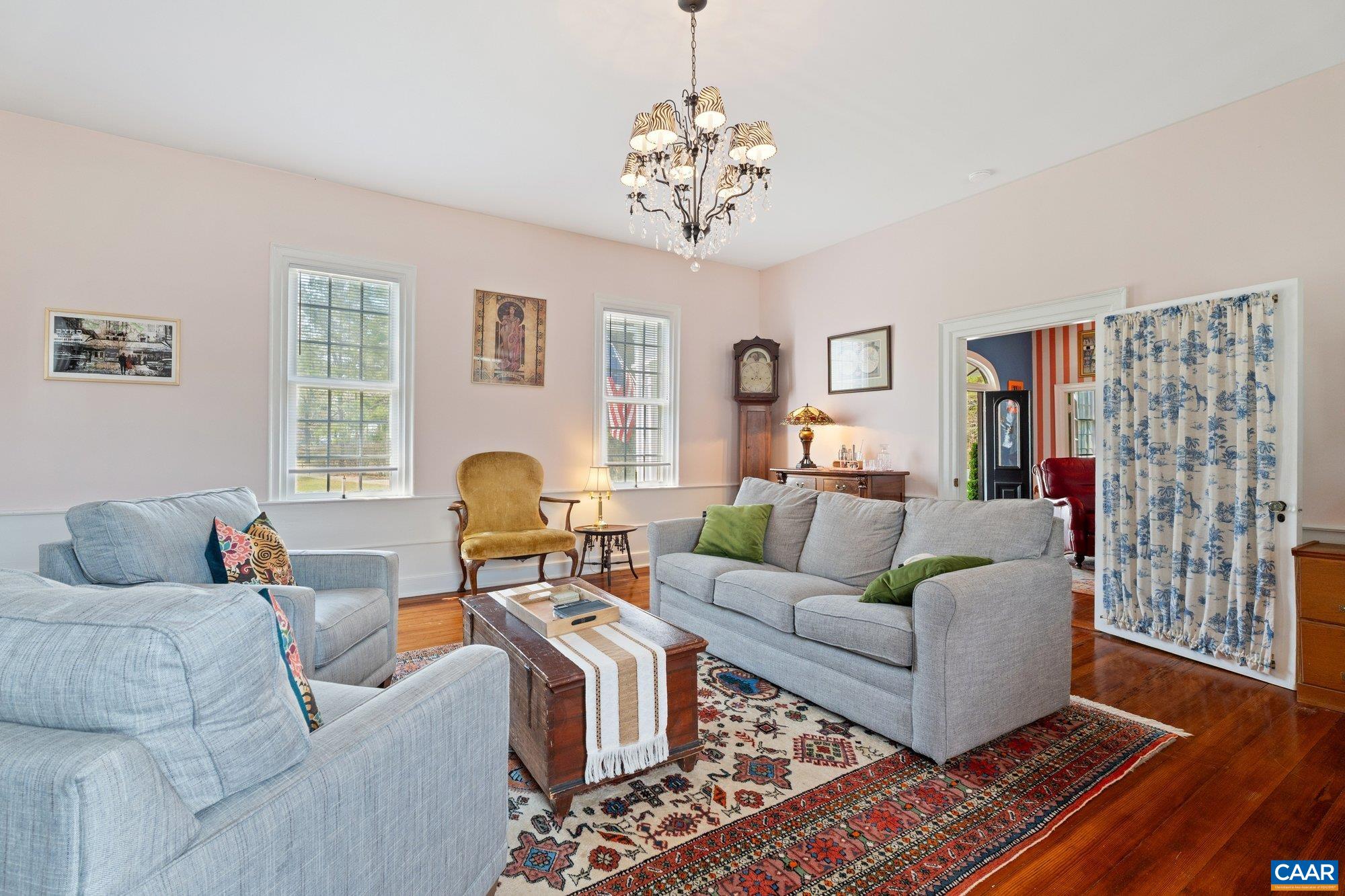 14910 Western Mill Road Lawrenceville, VA 23868 - Photo 21 of 73 a living room with furniture a chandelier and a window