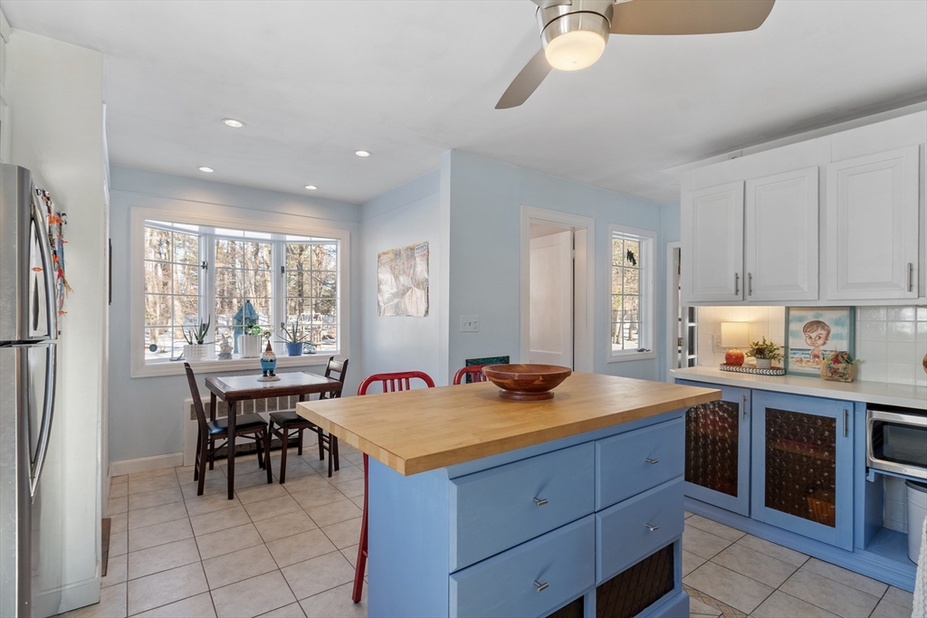 45 Main Street Chelmsford, MA 01863 - Photo 11 of 42 a kitchen with a stove a refrigerator and a dining table