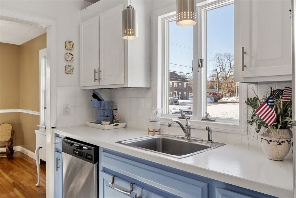 45 Main Street Chelmsford, MA 01863 - Photo 12 of 42 a kitchen with stainless steel appliances a sink a window and cabinets