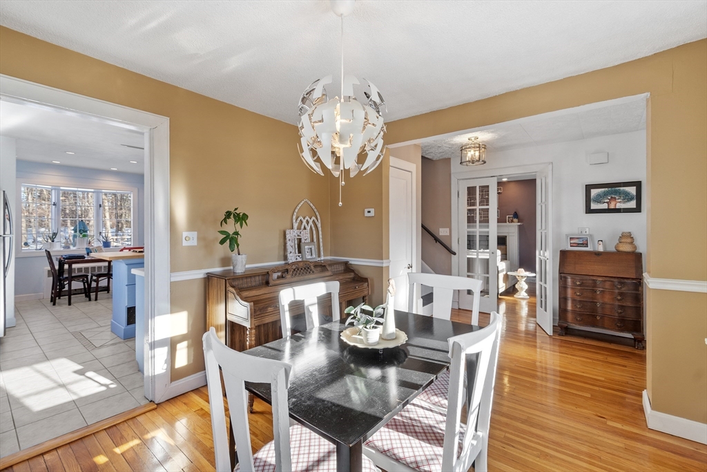 45 Main Street Chelmsford, MA 01863 - Photo 18 of 42 a view of a dining room with furniture a chandelier and wooden floor