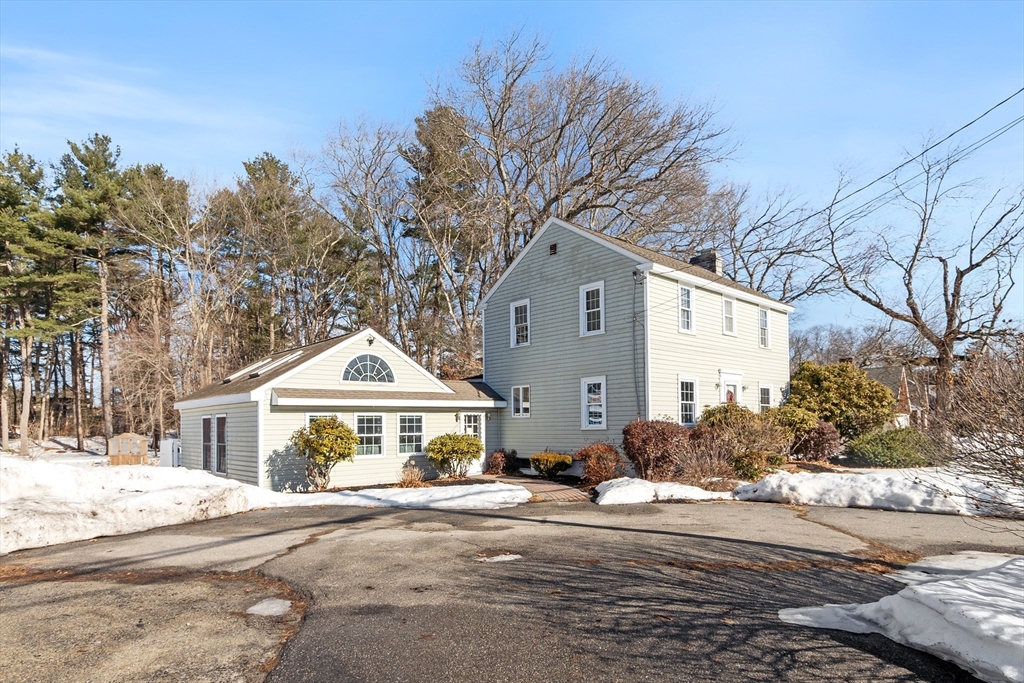45 Main Street Chelmsford, MA 01863 - Photo 2 of 42 a front view of a house with a yard and garage