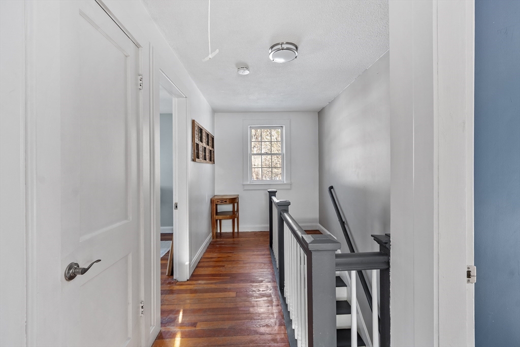 45 Main Street Chelmsford, MA 01863 - Photo 29 of 42 a view of a hallway with wooden floor and a bathroom