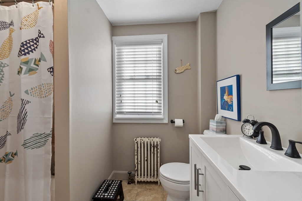 45 Main Street Chelmsford, MA 01863 - Photo 34 of 42 a bathroom with a sink a toilet and a window