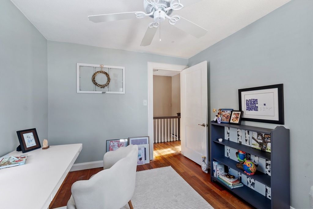 45 Main Street Chelmsford, MA 01863 - Photo 36 of 42 a living room with furniture and a book shelf