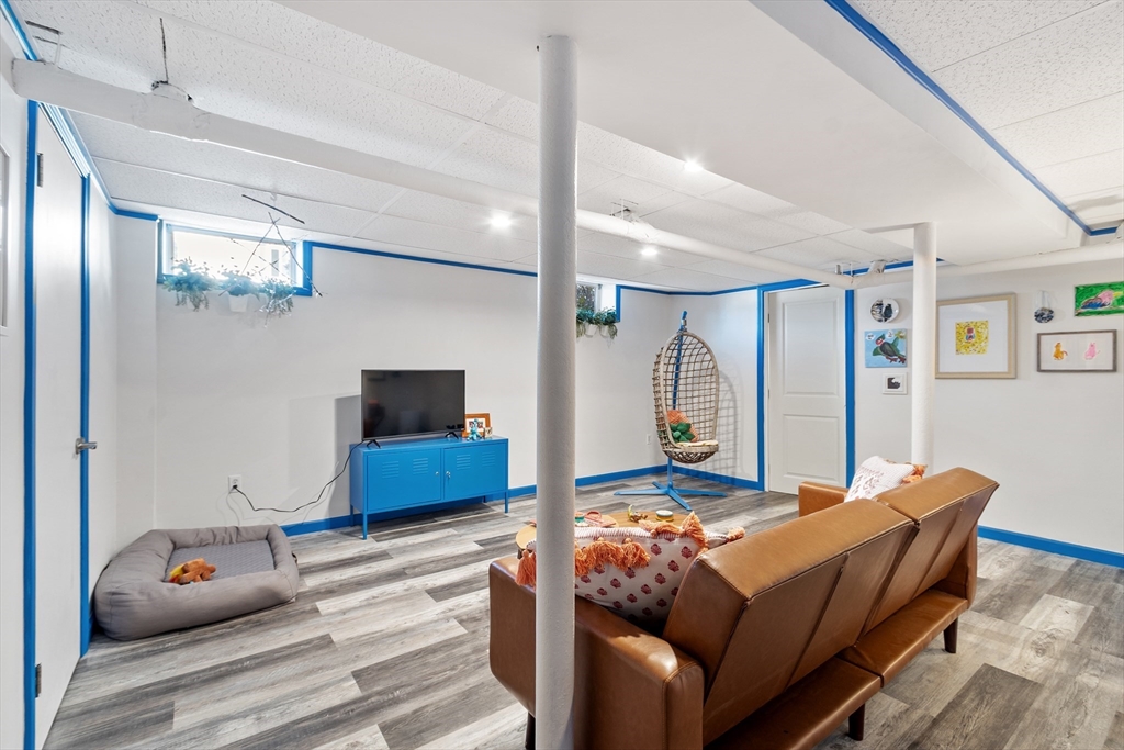 45 Main Street Chelmsford, MA 01863 - Photo 39 of 42 a living room with furniture a flat screen tv and a large window