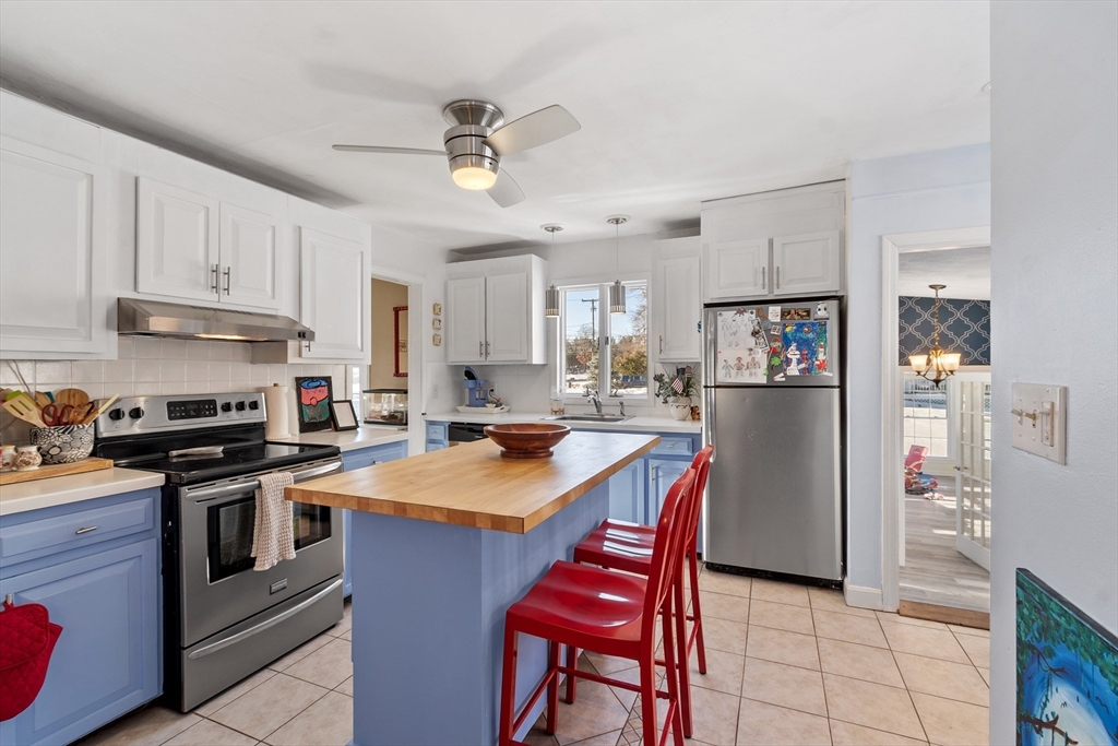 45 Main Street Chelmsford, MA 01863 - Photo 7 of 42 a kitchen with stainless steel appliances granite countertop a stove top oven a sink a stove and a refrigerator