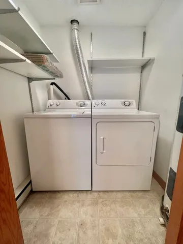a view of a storage & utility room with washer and dryer
