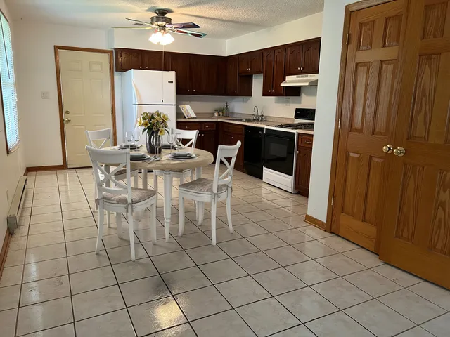 a view of kitchen with furniture wooden floor and window