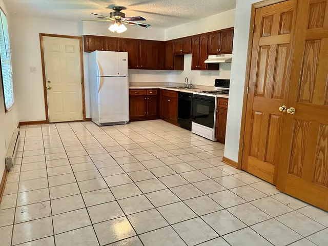 a kitchen with stainless steel appliances a refrigerator and a stove top oven