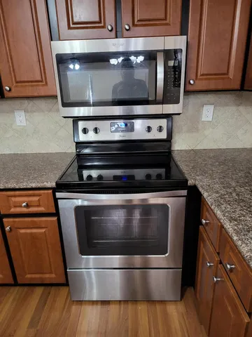 a stove top oven sitting inside of a kitchen