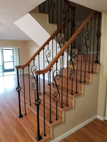 a view of entryway with wooden floor and stairs