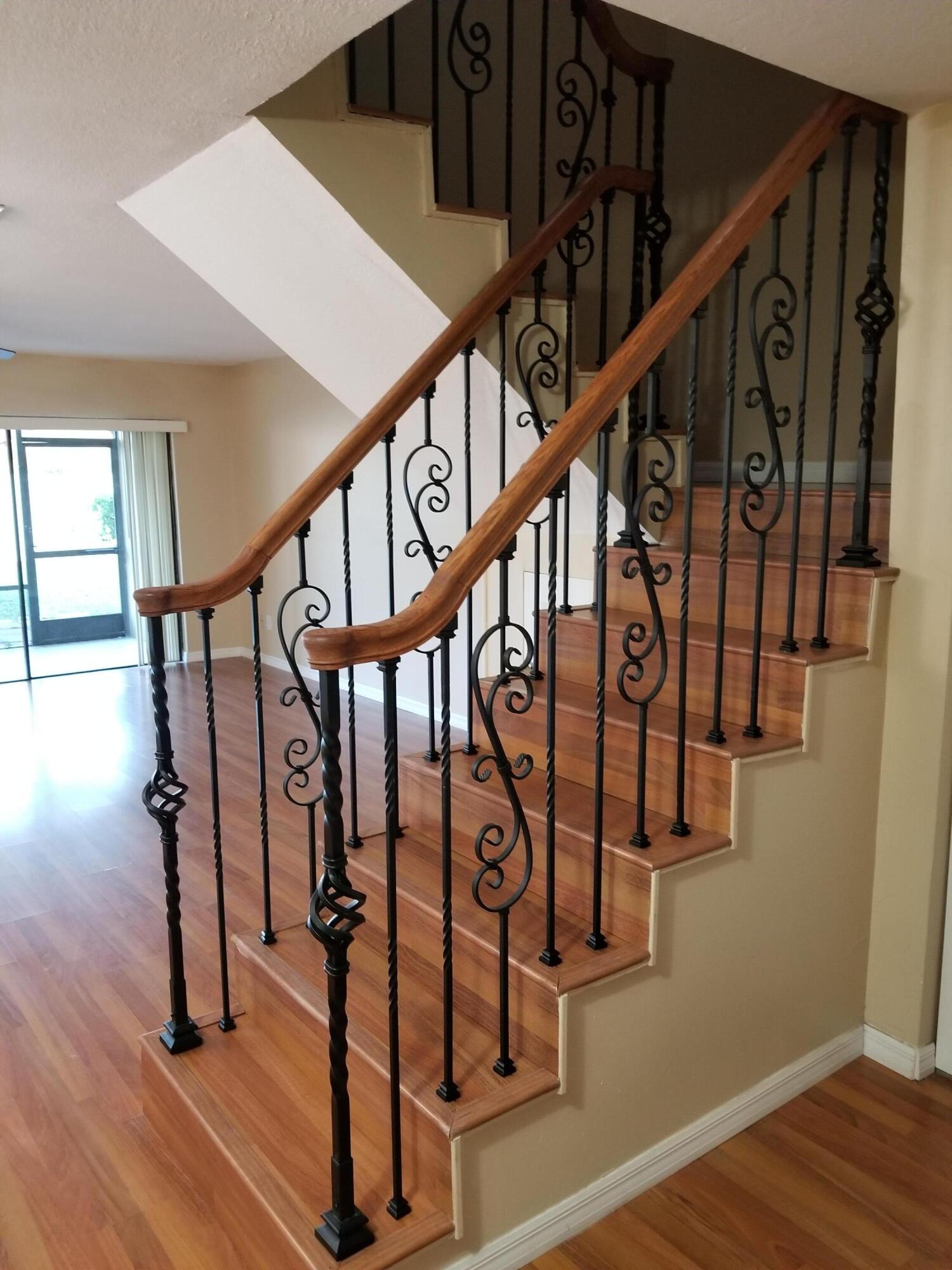 23312 Southwest 53rd Avenue, Unit C Boca Raton, FL 33433 - Photo 8 of 14 a view of entryway with wooden floor and stairs