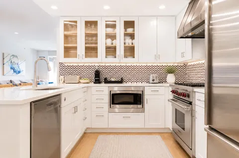 a kitchen with a stove a sink and a refrigerator
