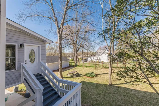 a kitchen with a sink a stove a refrigerator and white cabinets
