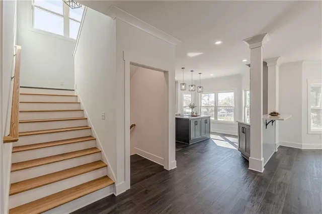 a view of an empty room with a window and a ceiling fan