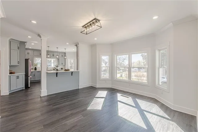 an empty room with closet and a ceiling fan