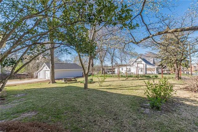 a view of a hallway with wooden floor and stairs