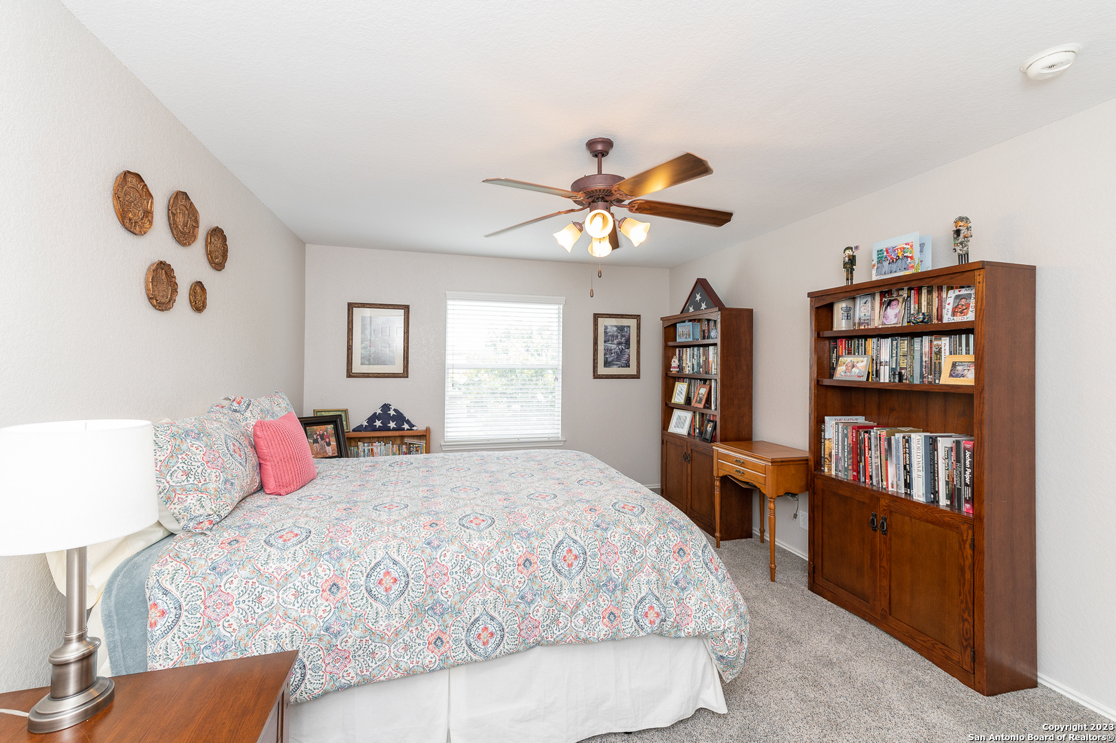 2604 Patron Village Schertz, TX 78108 - Photo 36 of 52 a bedroom with a large bed and a book shelf