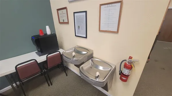 a bathroom with a granite countertop toilet and a sink