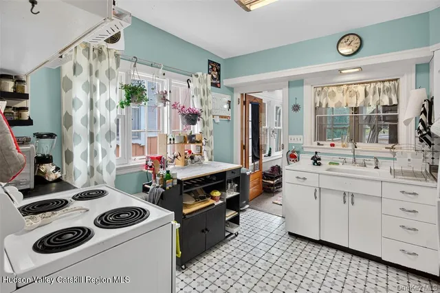 a room with stainless steel appliances kitchen island granite countertop a stove and a refrigerator
