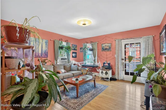 a living room with furniture a rug and a window