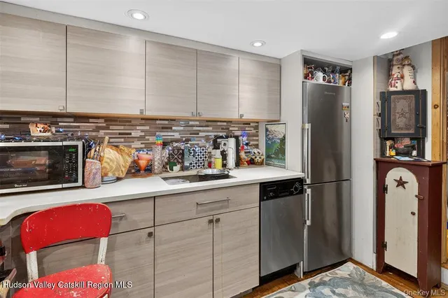 a bathroom with a granite countertop sink a mirror and shower