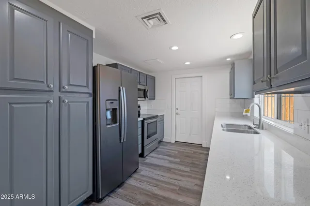 a kitchen with a refrigerator a sink and dishwasher