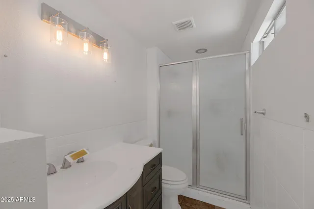 a bathroom with a shower and a sink